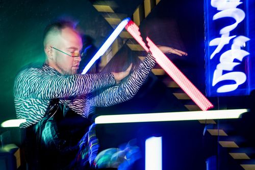 Free Dynamic portrait of a stylish man posing with neon lights and modern fashion in a cyberpunk setting. Stock Photo