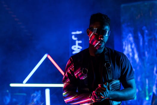 Portrait of a man wearing goggles with vibrant neon backgrounds in a futuristic setting.