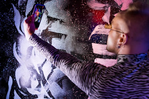 Man taking a cyberpunk-themed selfie against a vibrant graffiti wall.