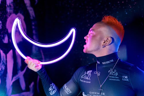 Man Holding a Moon Neon Light