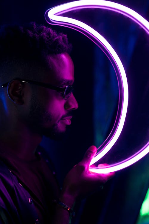 Man Holding a Neon Light