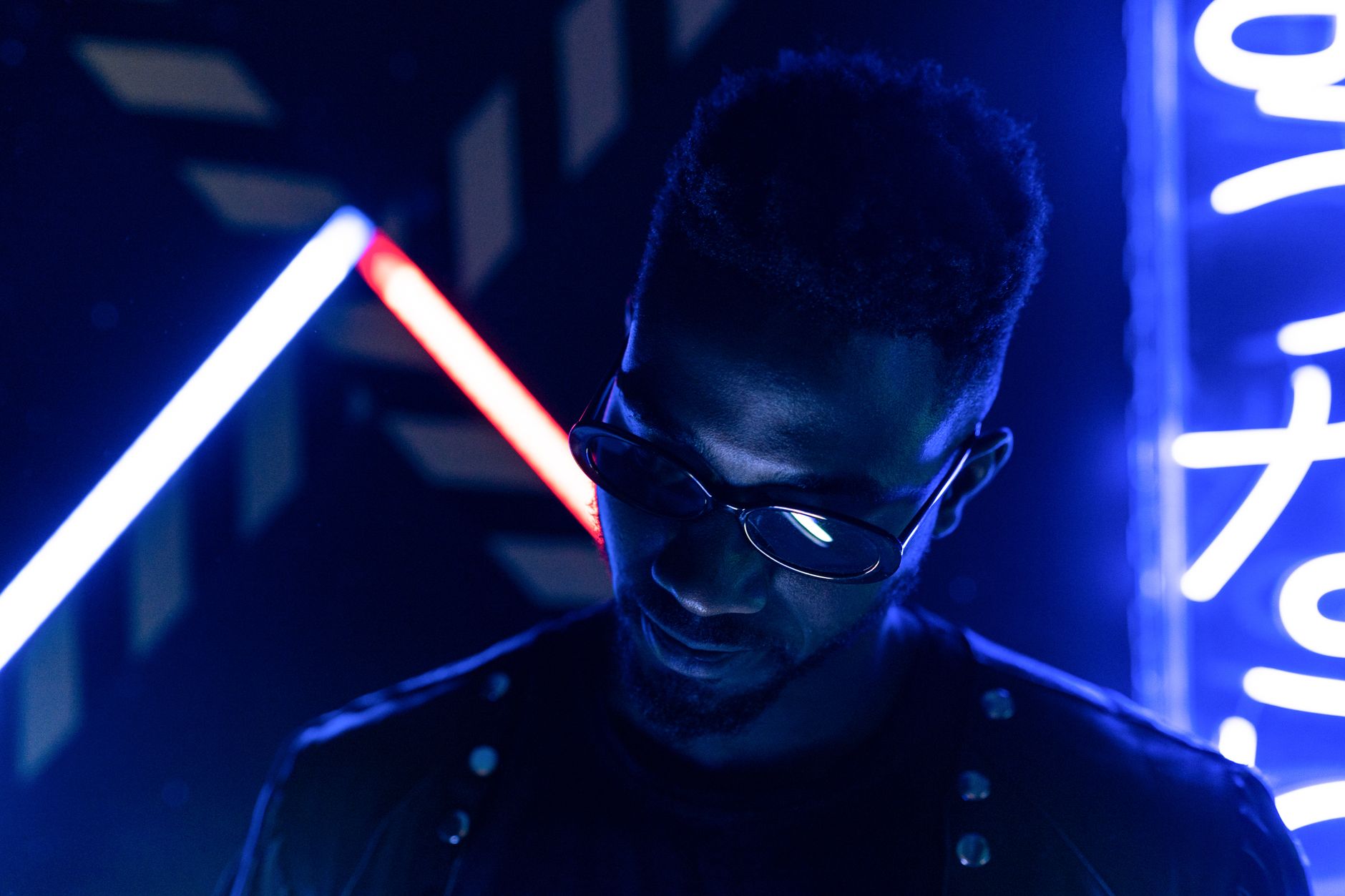 Single frame from an AI-generated Cyberpunk music video — neon-drenched streets aesthetic