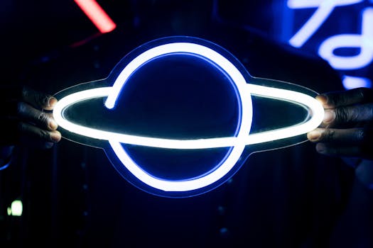 Illuminated neon Saturn sign held by hands with vibrant cyberpunk glow