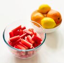 Close-Up Shot of Sliced Rhubarb in a Clear Bowl near Oranges and Lemons