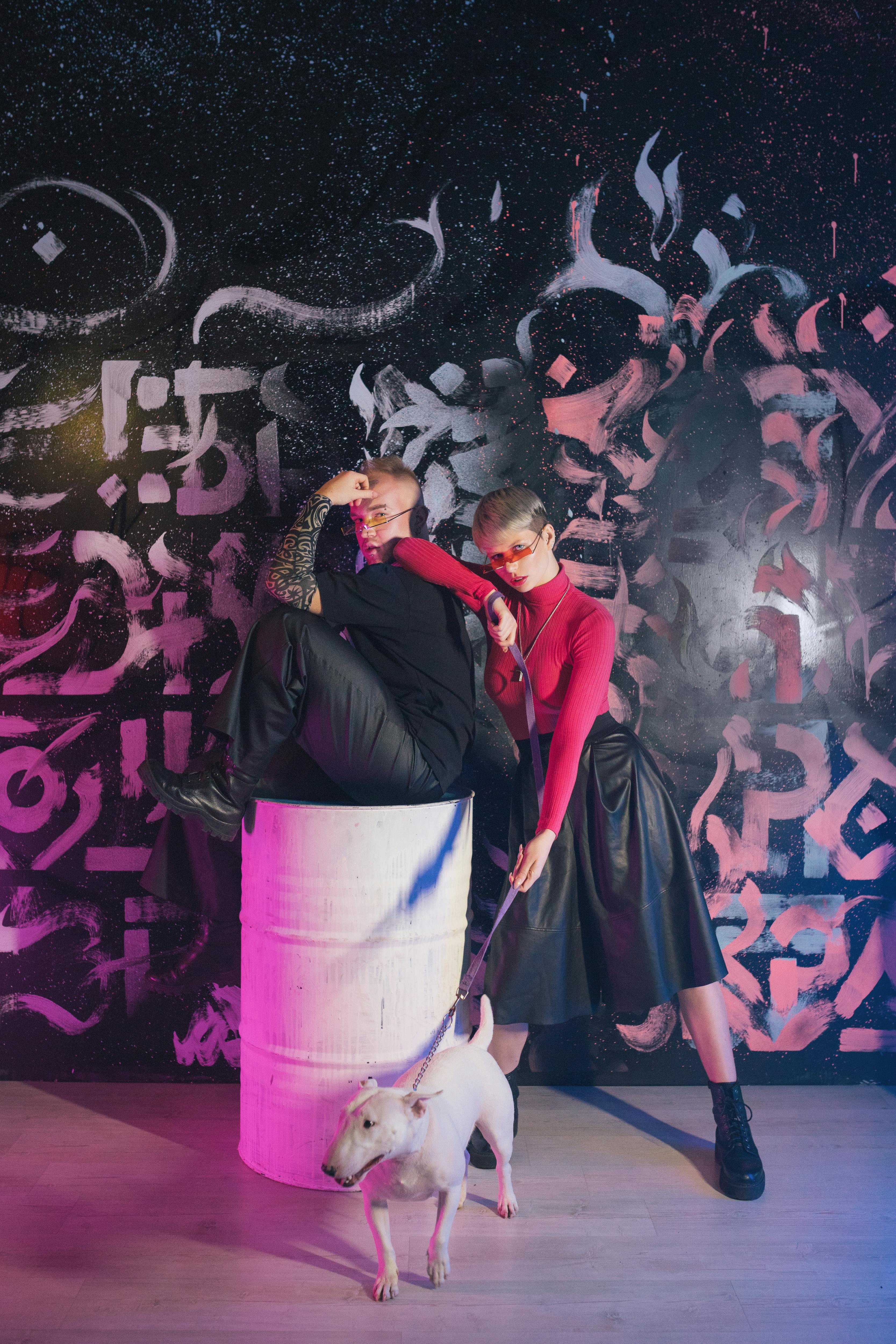 Woman Holding a Dog in a Leash