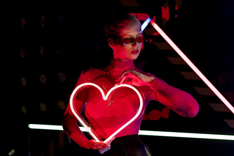 Woman Holding A Neon Heart Shape Light