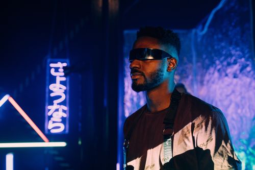 Free A man in cyberpunk style with neon lights and Japanese signage. Stock Photo