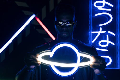 Free A Man Holding a Neon Lights Stock Photo