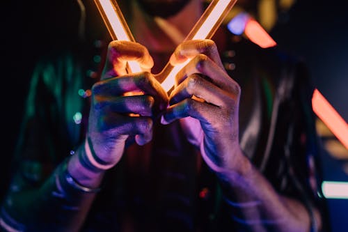 Free A Person Holding a Neon Light Stock Photo