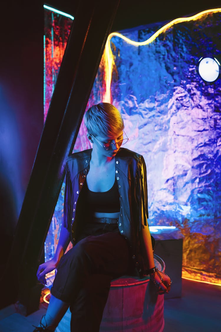 A Woman In Black Crop Top Sitting On A Drum