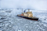 Black and Gray Ship on Water With Ice