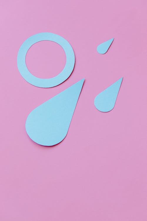 Blue Paper Cut Outs on a Pink Surface