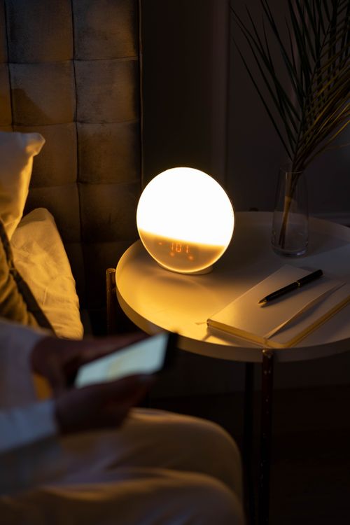A warm, cosy bedside setting with a soft glow in the evening