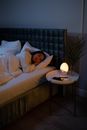 Woman Lying on Bed Covered With White Blanket