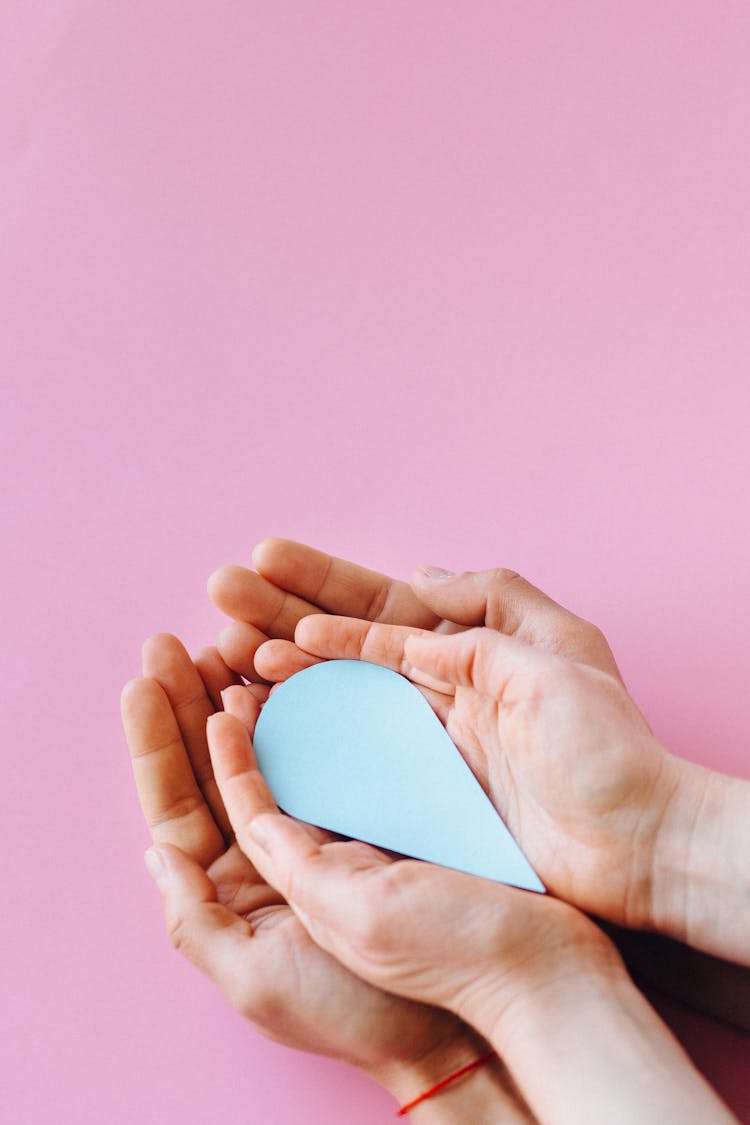 A Person Holding A Tear Shape Paper