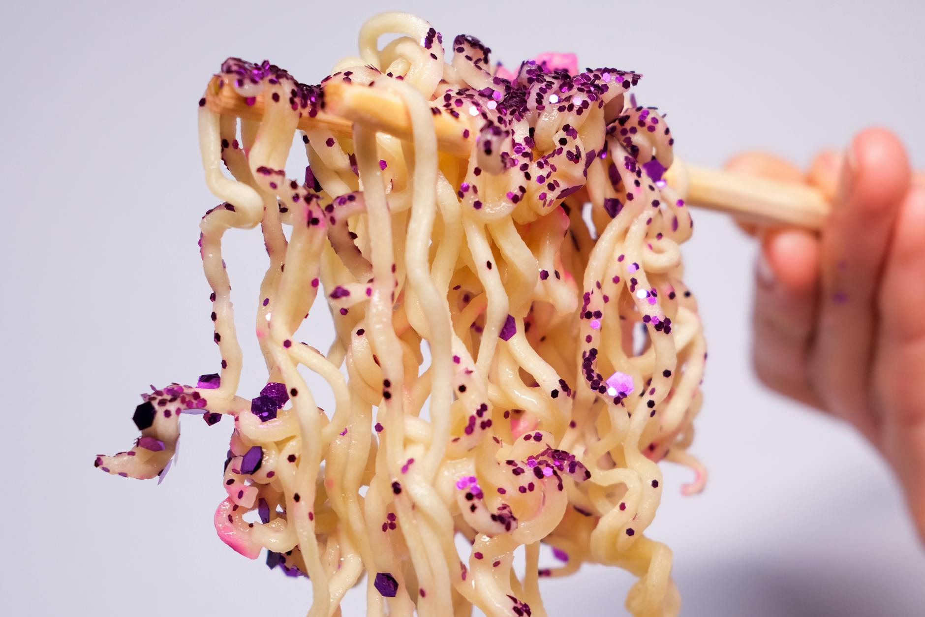 Closeup of crop unrecognizable person holding instant noodles