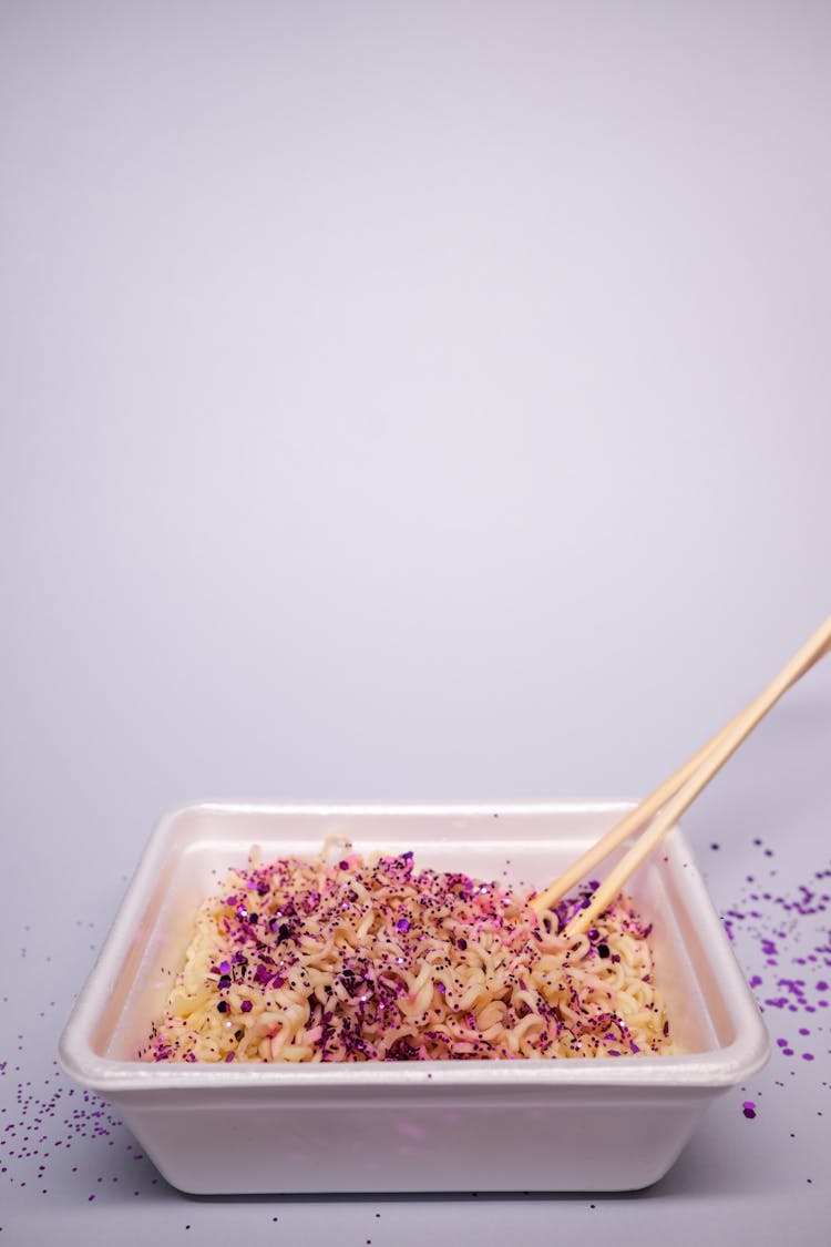 Plastic Bowl With Instant Noodles With Chopsticks In Studio