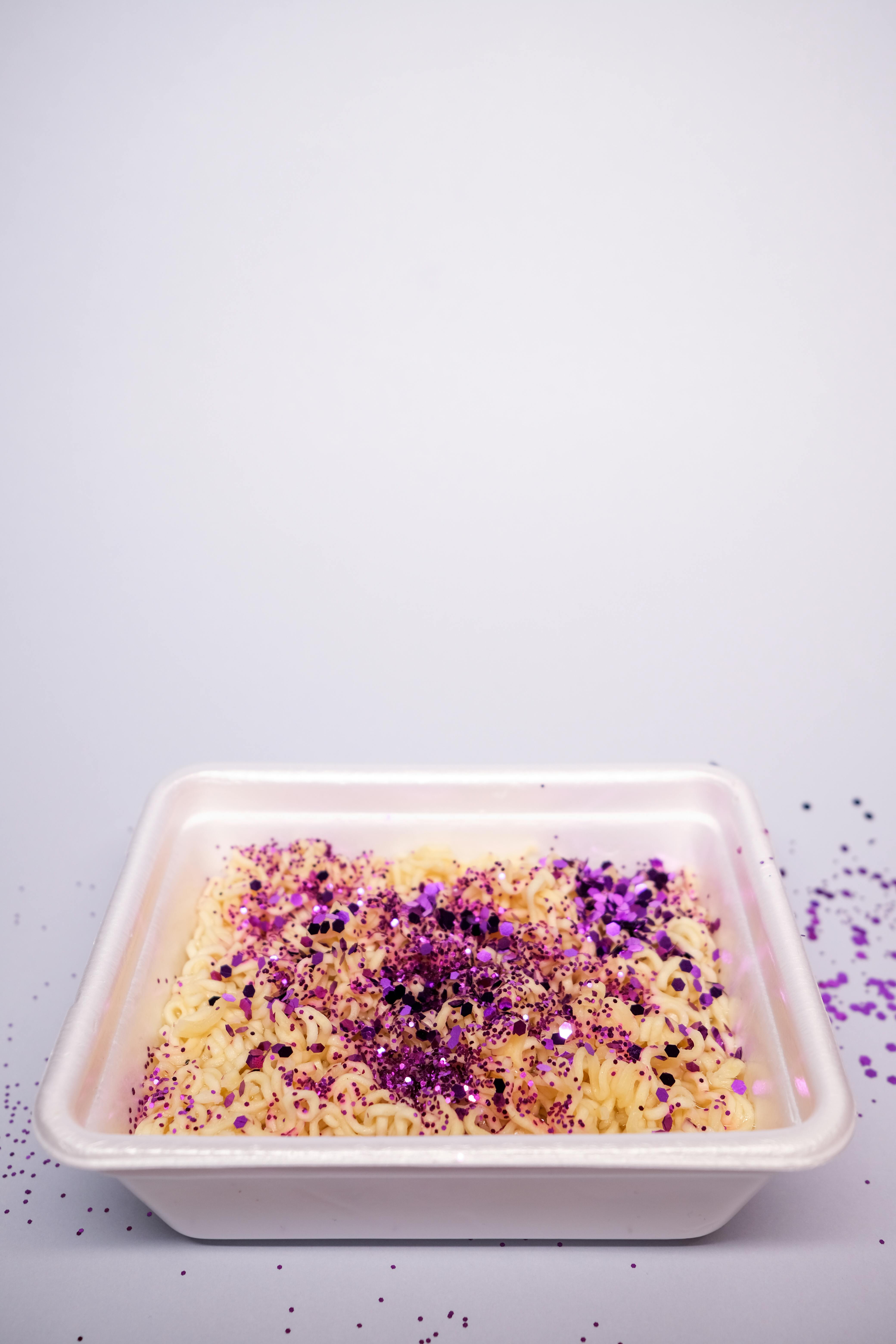 asian instant noodles in simple plastic container on white table