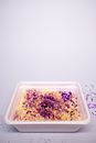 Asian instant noodles in simple plastic container on white table