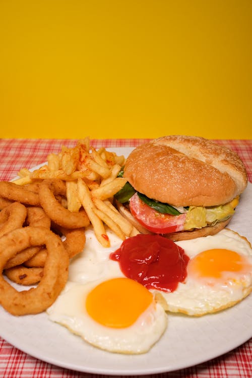 Free Delicious sandwich with fried potatoes and onions and eggs served on plate Stock Photo
