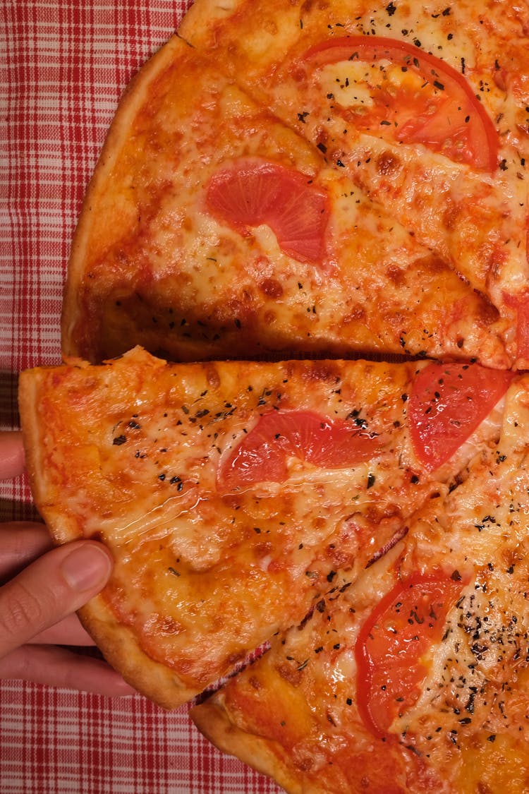 Faceless Man With Pizza Slices On Table