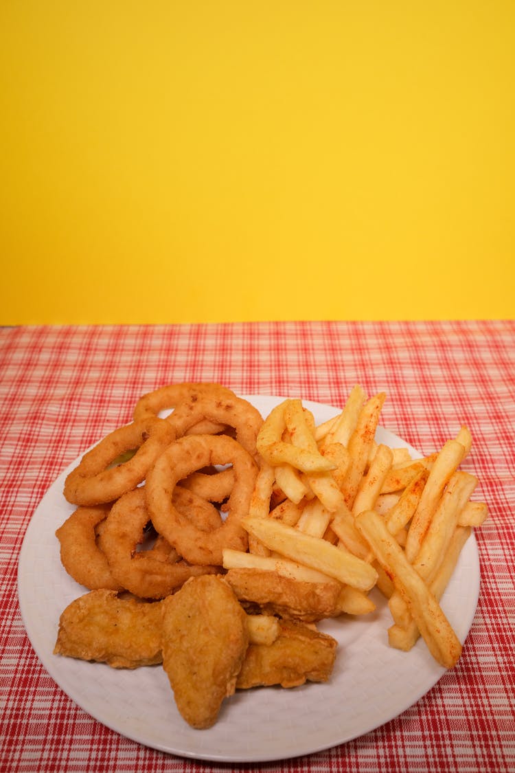 Plate With French Fries And Onion Rings With Nuggets