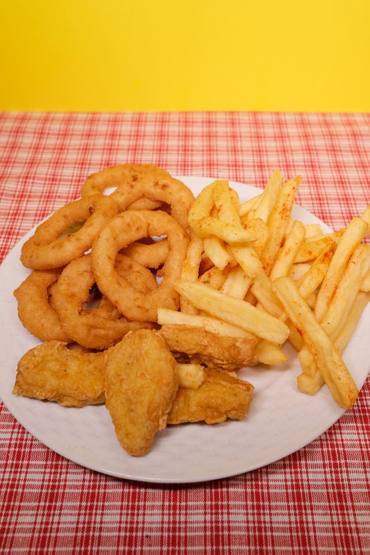 Plate With Onion Rings And French Fries With Nuggets