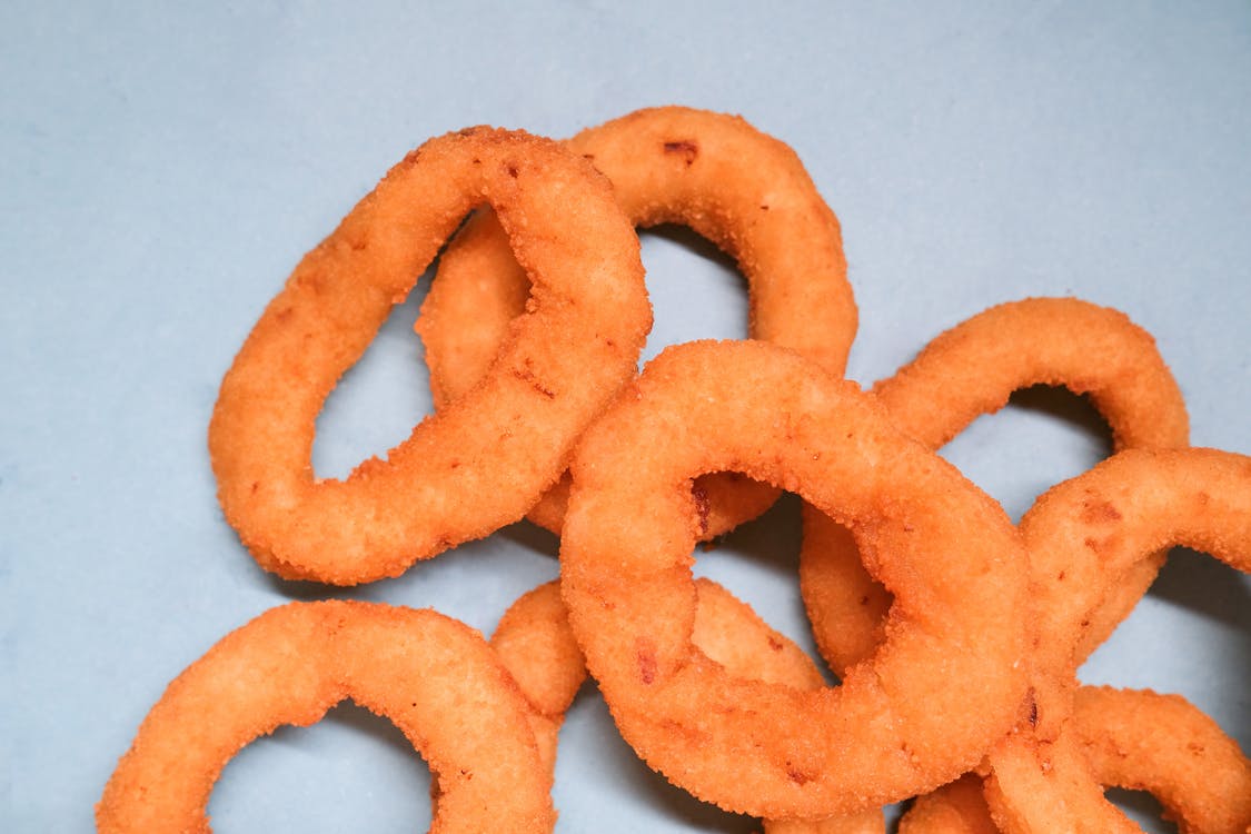 Deep fried onion rings on blue background