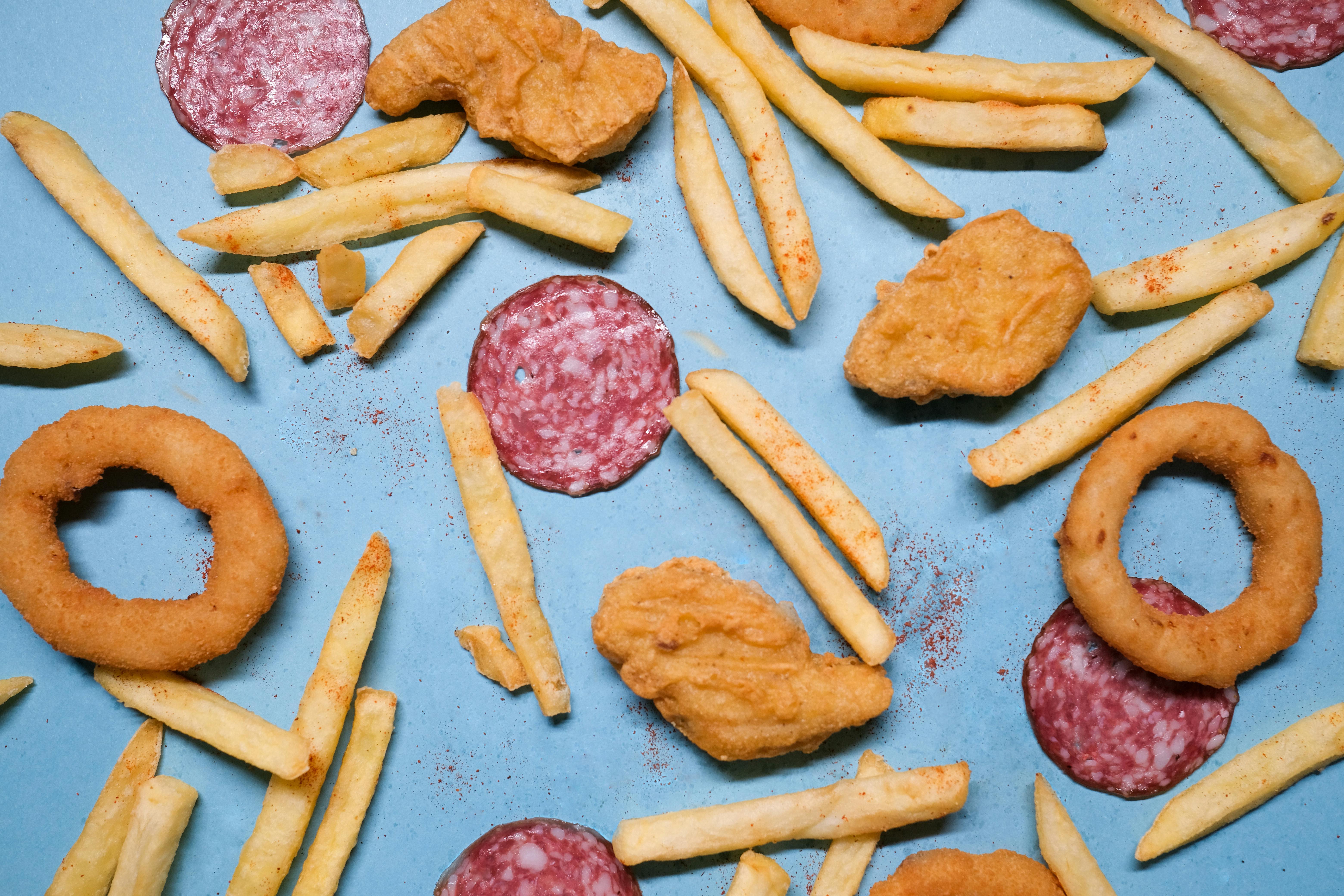 salami with onion rings and nuggets near french fries