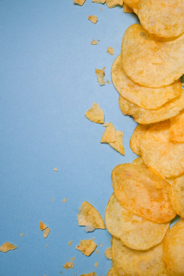 Golden Crisps Placed On Blue Background