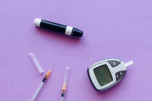Free Diabetic Kit and Insulin over a Purple Surface Stock Photo