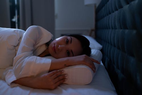 Free A Woman Lying in Bed Stock Photo