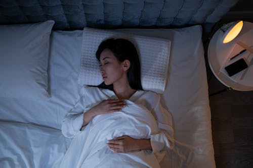 Woman Sleeping on a Bed