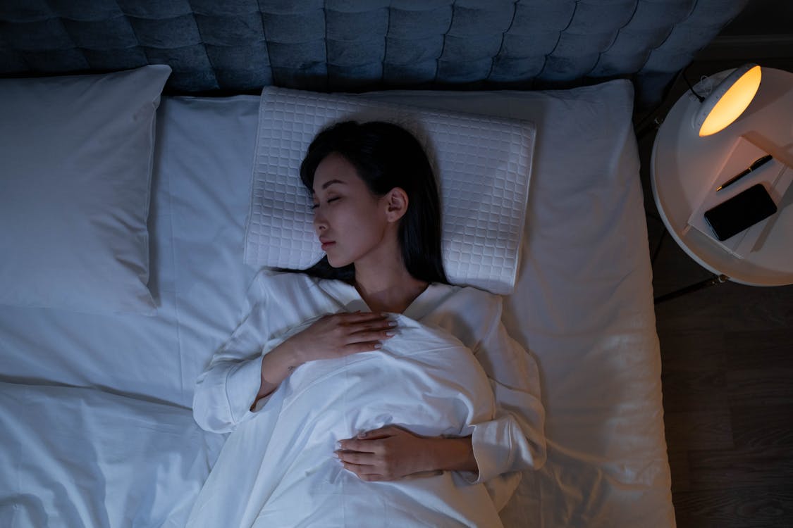 Free Woman Sleeping on a Bed Stock Photo