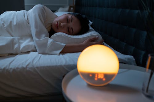 Free Baby in White Long Sleeve Shirt Lying on Bed Stock Photo