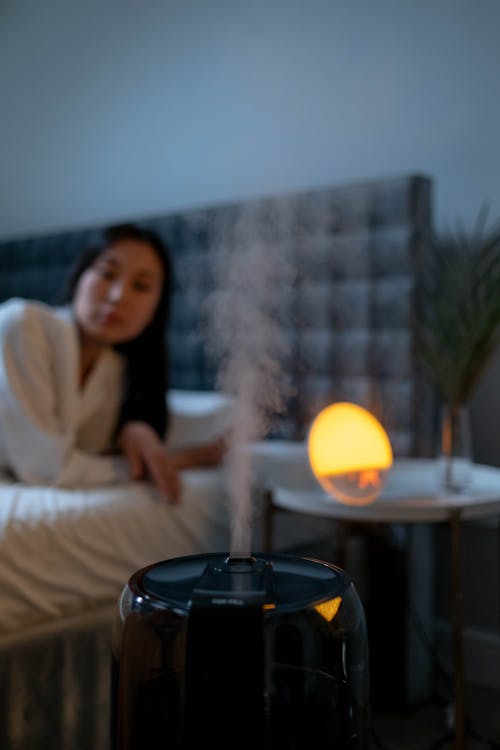 Free Woman in the Bedroom with Humidifier Stock Photo