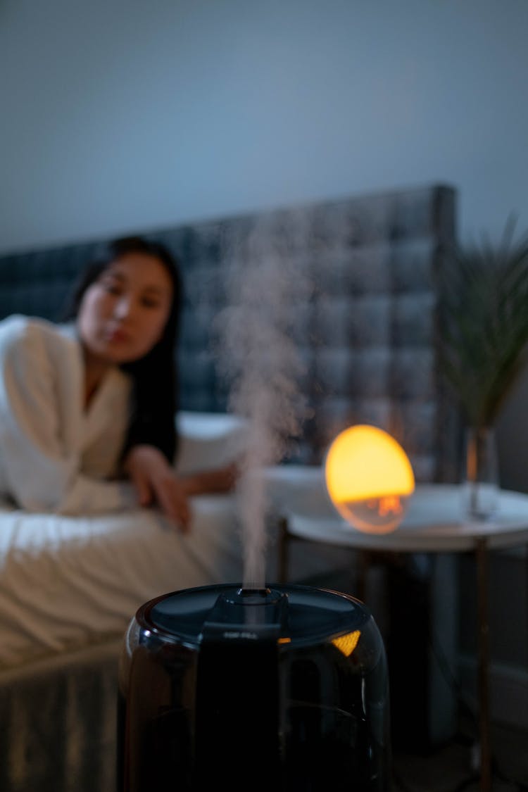 Woman In The Bedroom With Humidifier