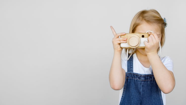 Girl Taking Photo Using A Camera