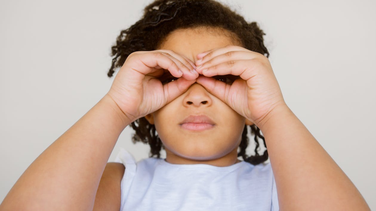 Girl in White Crew Neck T-shirt Covering Her Eyes With Her Hands