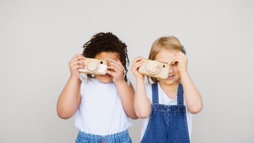 Two Kids Taking Photo Using a Camera