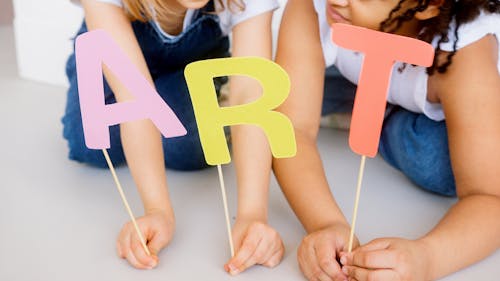 Two Kids Showing Their Artworks