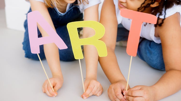 Two Kids Showing Their Artworks