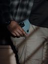Man pulling smartphone out of pocket of pants