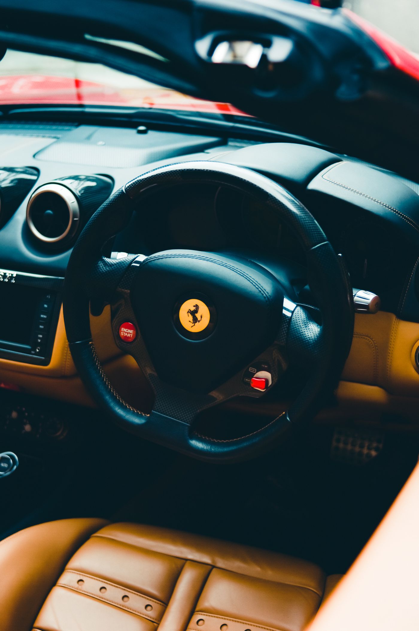 Premium vehicle interior showing a leather steering wheel and dashboard