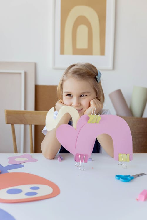 Free Girl Smiling While Doing Her Artwork Stock Photo