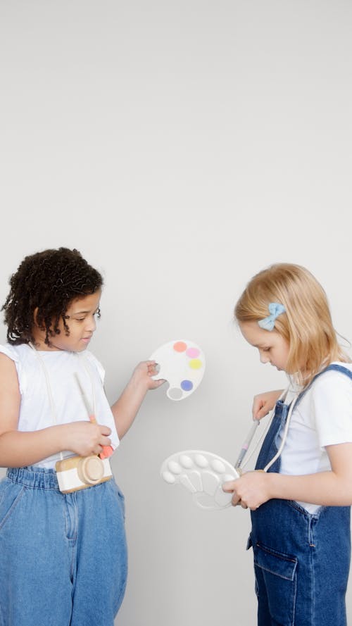 Two Kids Holding a Paintbrush and a Palette