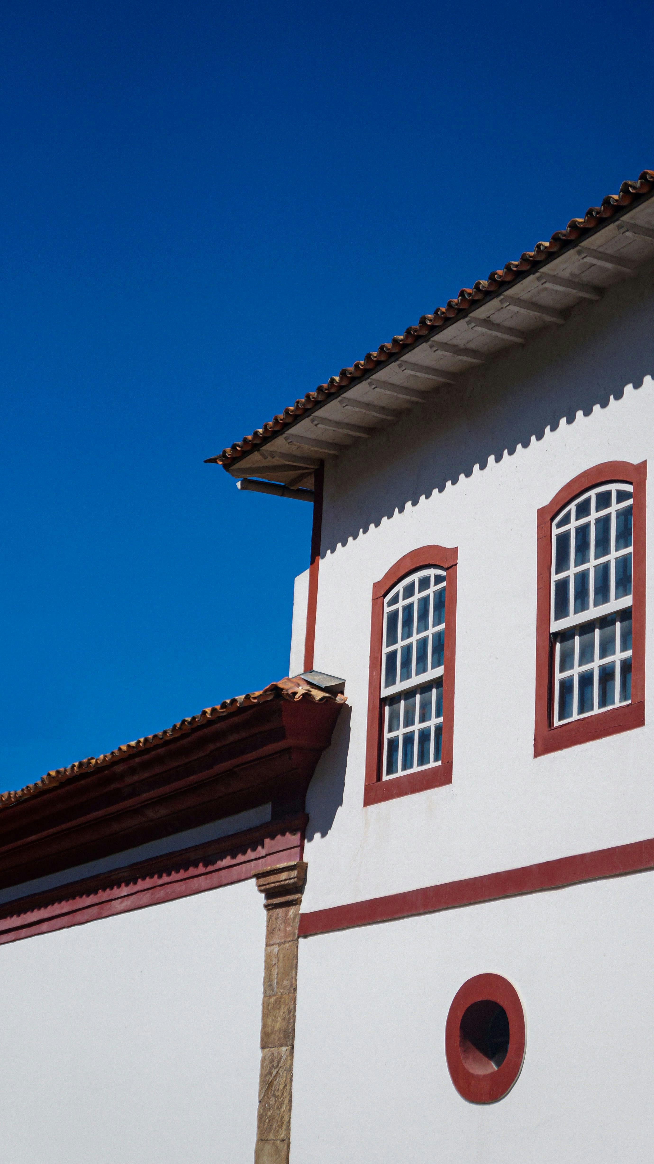 Person holding a heart-shaped bowl of fresh fruits and vegetables