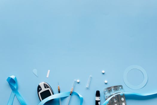 Flat lay of diabetes awareness items and medical tools on a blue background. Ideal for health campaigns.