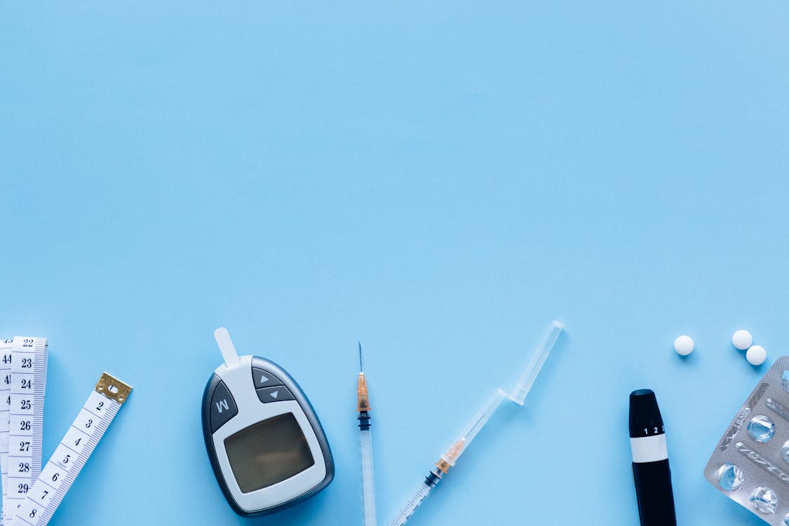 Free Digital Blood Sugar Meter with Injections and Medication Stock Photo