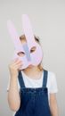Girl Covering Her Face With a Cutout Animal Mask